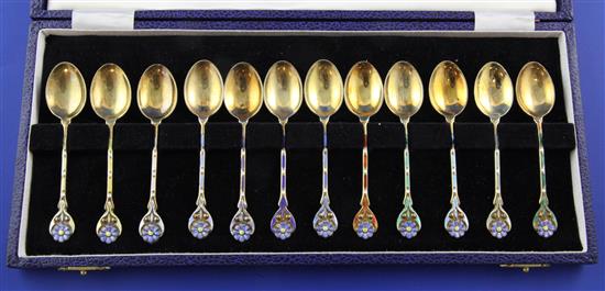 A cased set of twelve 1970s silver gilt and enamel coffee spoons,